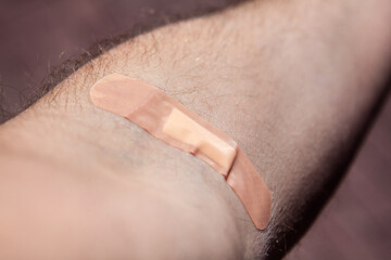 Band-aid on hand after vaccination . Place after injection