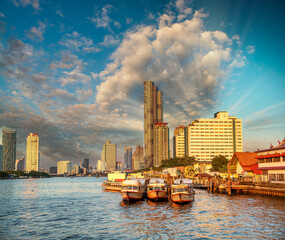 Bangkok, Thailand - January 5, 2020: Chao Phraya River and city skyscrapers from Asiatique Waterfront at sunset.