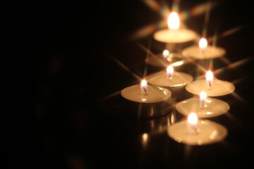 Light several candles on a wooden table