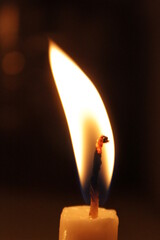 Lit candles light up a dark night.