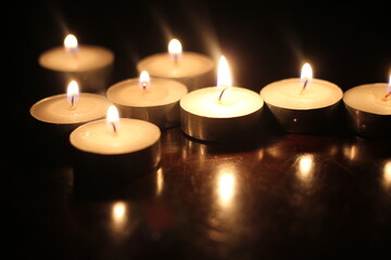 Light several candles on a wooden table