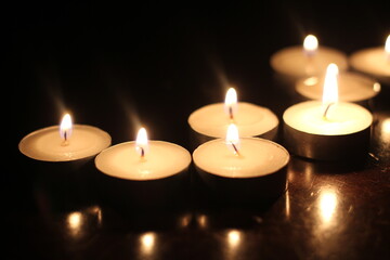 Light several candles on a wooden table