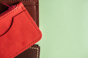 handmade wallet made of red and leather on a mint background close-up with a place for an inscription