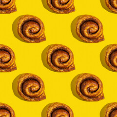 Seamless pattern with sticky buns on yellow background.