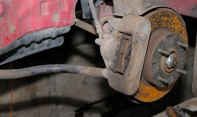 Brake system of a car. Brake disc with traces of oxidation and brake caliper on a car