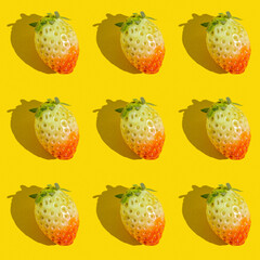 Seamless pattern with fresh organic strawberries on yellow background.