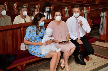 Religious mass in the church with people with masks on their faces during a pandemic