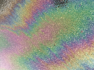 Gasoline that had leaked onto a wet asphalt