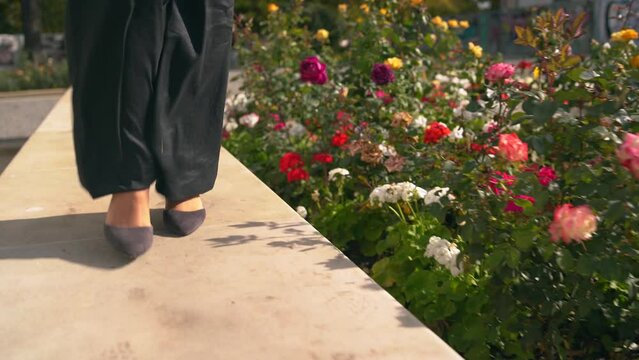 Woman wearing black in high heels shoes walking.close up.