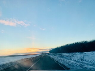 Sunrise over winter road