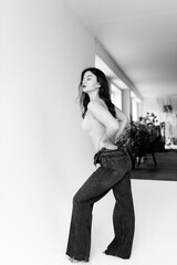 Young model girl in studio posing in top and pants