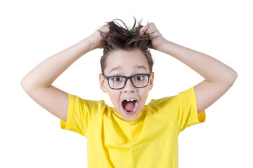 Portrait of an emotional teenager. The boy screams with joy and surprise, holding on to his shaggy hair.