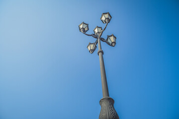 Fototapeta na wymiar pillar with a lantern on a blue sky background