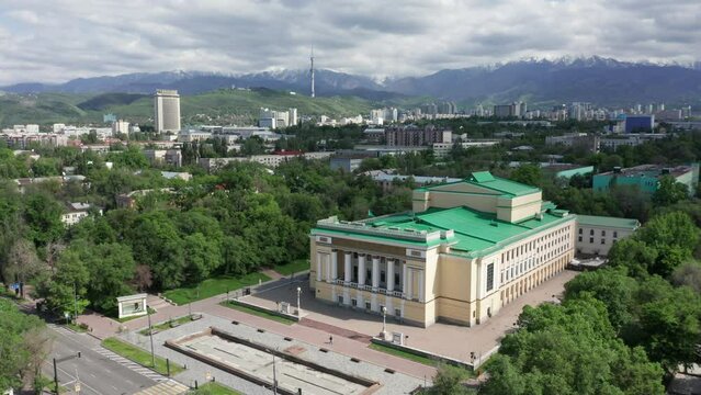 Aerial view of Opera and Ballet Abay Theatre at summer bright sunny day. Almaty city center aerial view with main city attractions. Historical center of Almaty city.