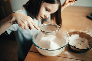 A girl cooks a pie in the kitchen, isolation exercise for a child
