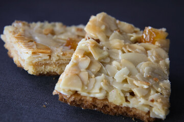 Peanut cookies with nuts and dried fruits on top on a blue background, blurred