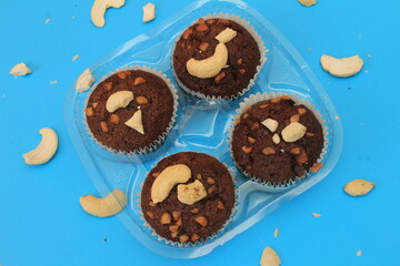 Chocolate muffin isolated on color background. Delicious chocolate muffin with nuts.
