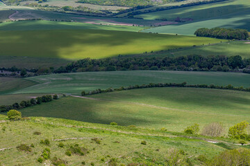 Clouds casting shadows over the South Downs hills, on a sunny spring day