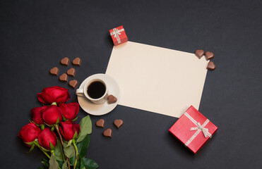 Cup of coffee, empty card for your text, gifts, heart shape chocolate candies and red roses.