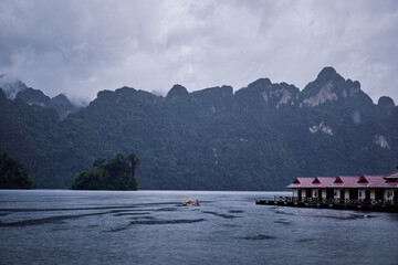 Bungalows on Cheow Lan Lake in Khao Sok National Park at rain time, Surat Thani Province, Thailand.