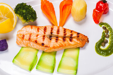 Special fish plate made by a restaurant chef with broccoli lemon avocado and tomatoes