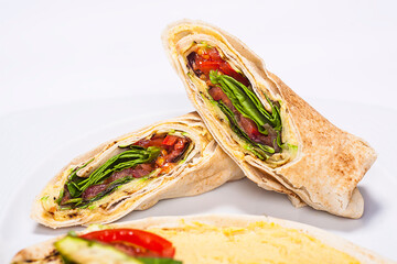Traditional Arabic food "Shaorma" plate made out of tomatoes, salad and meat rolled in a pita