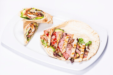 Traditional Arabic food "Shaorma" plate made out of tomatoes, salad and meat rolled in a pita