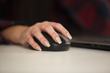 Businesswoman clicking with mouse. Young woman with long nails using wireless manipulator for work...