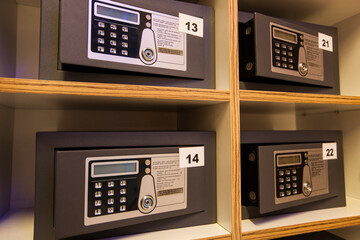 four safes arranged in a wooden shelf