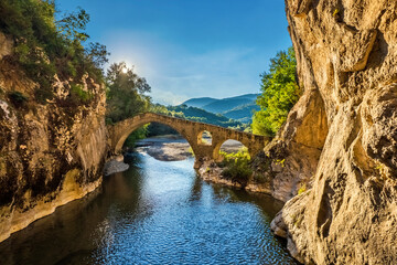 The old stone arched bridge and the canyon of Portitsa, close to Spilaio village, Grevena, West Macedonia, Greece. - obrazy, fototapety, plakaty