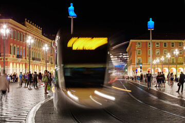 Fototapeta premium Square Massena in Nice - France at night, Avenue Jean Medecin, a lot of tourists, night illumination, statue