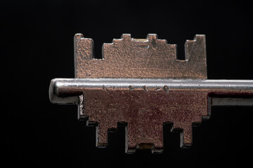 Old key on black background. macro photography. Dark background