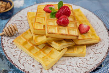 sweet dessert Belgian waffles with strawberries on a plate