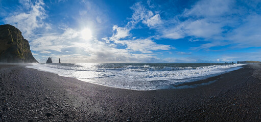 The famous Black Sand ocean Beach panorama. Mount Reynisfjall with Picturesque Basalt Columns and...