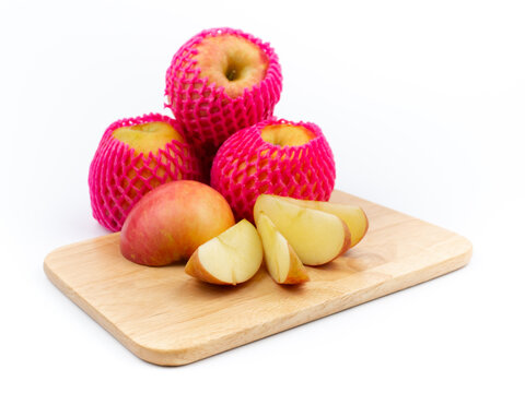 delicious fruit Red ripe apples and sliced apples on a cutting board on a white background.