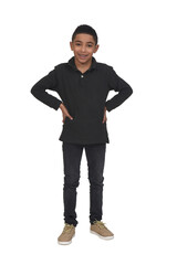 full portrait of a boy standing and looking at camera and hands on hip on white background