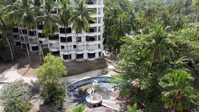 Abandoned hotel of swim pool grow with coconut trees