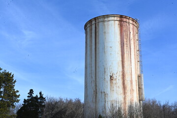 old rusted white water tower