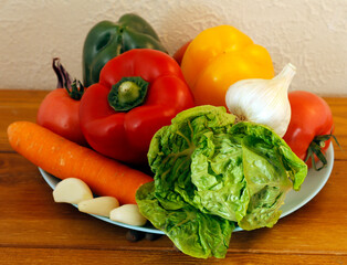 Vegetables for a fresh salad. Peppers, tomatoes, garlic, carrots and herbs.