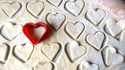 heart shape of soft rolled dough with wooden rolling pin for valentine's day