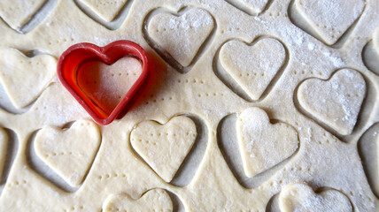 heart shape of soft rolled dough with wooden rolling pin for valentine's day