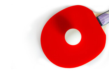 A red ping pong racket with a white ball on a white background. Top view, copy space. Sports, table tennis, sports equipment