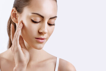 Young woman applying cream to her face. Skincare and cosmetics concept.Cosmetics. Woman face skin care.
