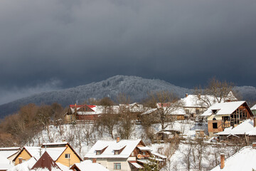 storm clouds over a village in winter