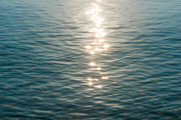 Detail of a sunlight reflecting in glittering sea. sparkler in water - background. sea water with...