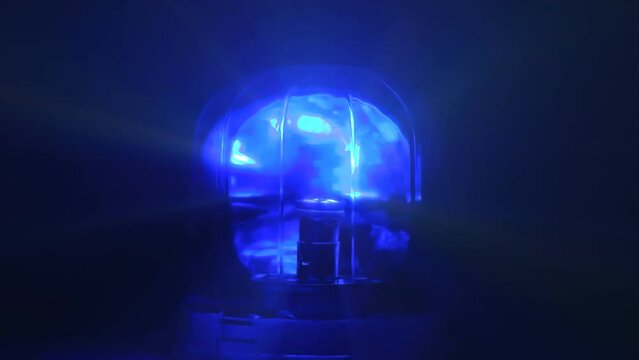 Warning alarm siren rotating and blinking at dark