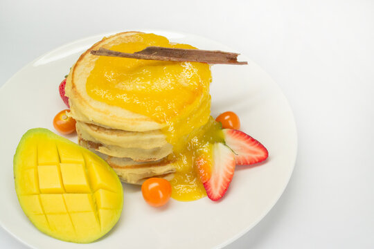 sweet and healthy breakfast with pineapple jam, fruits and pancakes