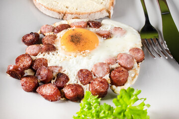 Fried egg with chopped sausage.