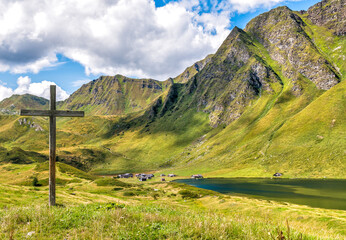 Old wooden cross in the park of the alpine lakes, Cadagno. Piotta, canton Ticino of Switzerland. © EleSi
