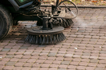 The municipal service conducts seasonal work in the park. The sweeper picks up a lot of debris. The brushes sweep the asphalt